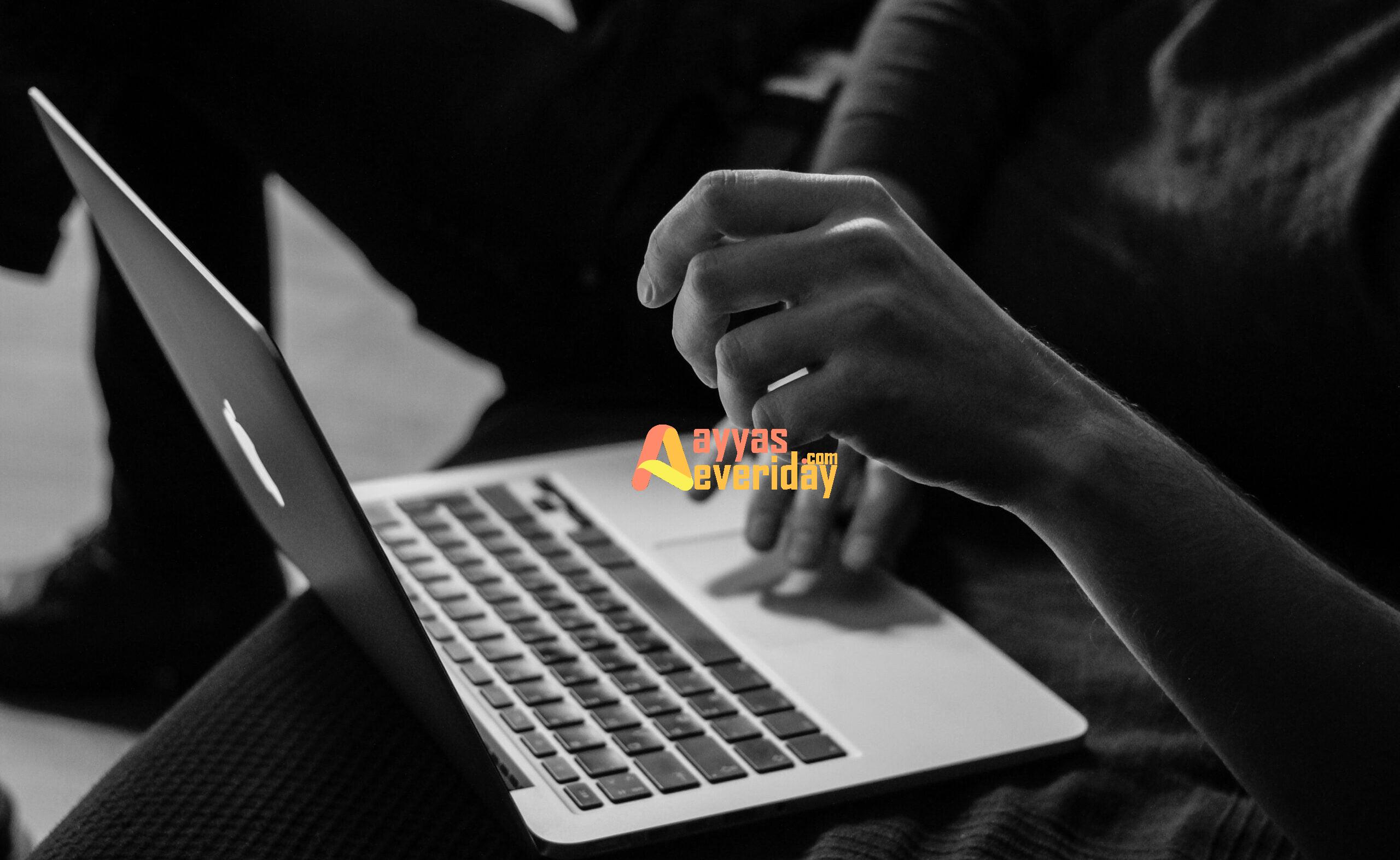 grayscale photo of person using MacBook