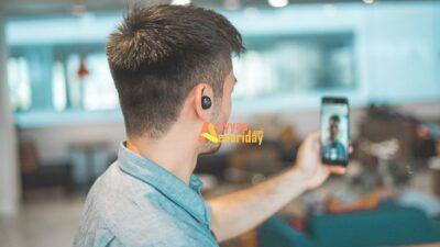 shallow focus photo of man in gray collared top taking selfie