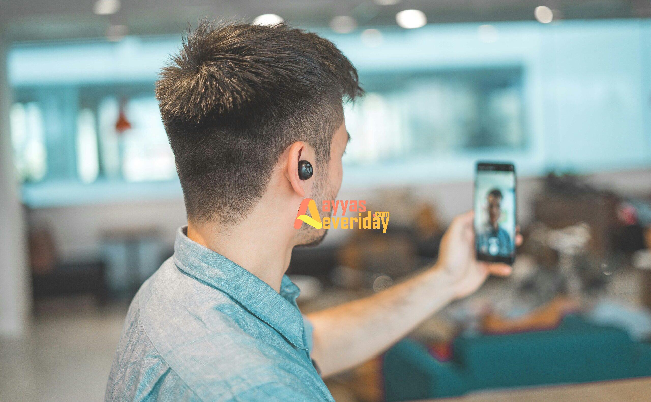 shallow focus photo of man in gray collared top taking selfie