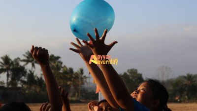 woman in black tank top holding blue balloon during daytime